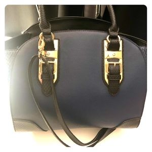 Navy blue purse with gold hard wear.